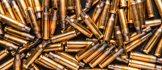 Empty cartridge cases for a carbine or rifle. Background of shiny brass cartridges for cartridges...