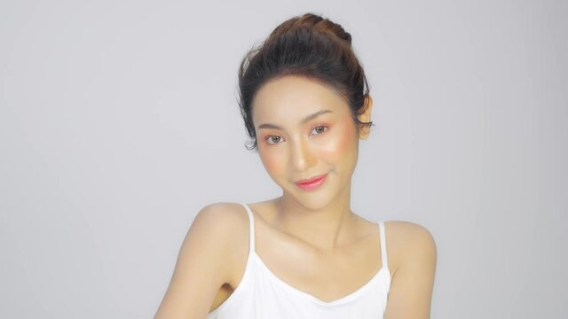Beauty Asian woman touch soft cheek smile Cosmetics facial treatment