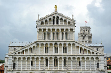 Fototapeta na wymiar Pisa cathedral and Pisa tower close to it in one cloudy day, Italy