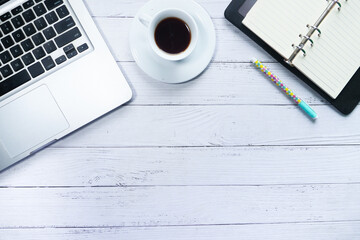 high angle view of laptop, tea and notepad on table 