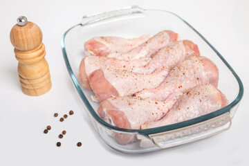 Chicken drumsticks with pepper on a white background