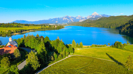 Obraz premium Lake Weissensee in Bavaria - beautiful small lake in the Allgau district - aerial drone footage