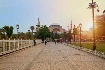 A view of the Hagia Sophia at dawn, at the end of a long, paved pedestrian area 