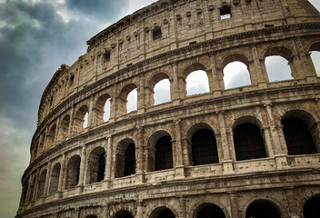 Fototapeta na wymiar historical roman empire colosseum with blue sky dramatic rome