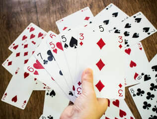 Human hand holding playing cards. Gambling concept. Poker card background