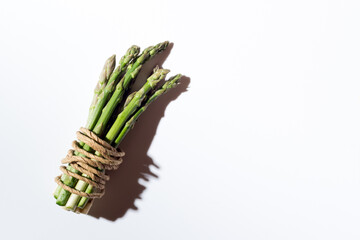 Green fresh asparagus on a gray background