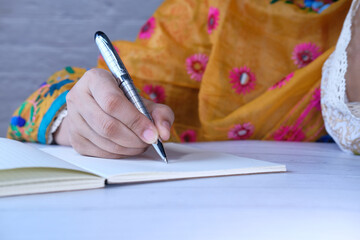 asian women hand writing in notebook with pen