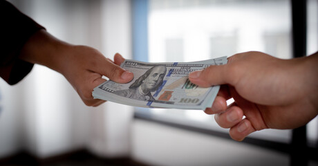 Businessmen give dollars under the table to bribe employees in signing contracts for the purchase...