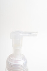 Fototapeta na wymiar Translucent Top Pump Of A Foam Soap Plastic Bottle Dispenser