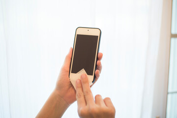 woman is cleaning cell phone