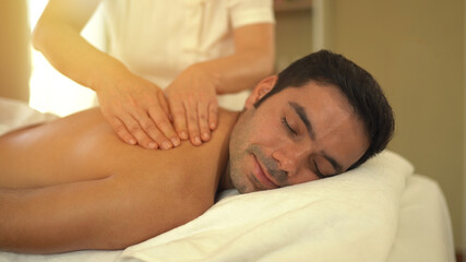 Young caucasian man relax during massage