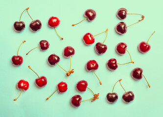 Naklejka na ściany i meble Fresh ripe cherry isolated on colorful background, seamless fruit abstract pattern