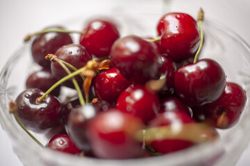 Fresh sweet cherry fruits in a glass bowl