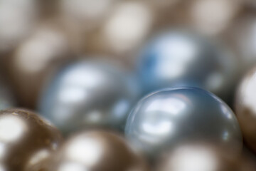 Beautiful opalescent glass beads closeup on black soft velvet background, abstract blur background