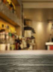 Blurred coffee shop background to promote your own coffee product. Just place your product in the middle of the frame, on the wooden bar for a pack shot