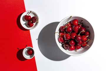 Fresh seasonal red cherries in strong sunlight