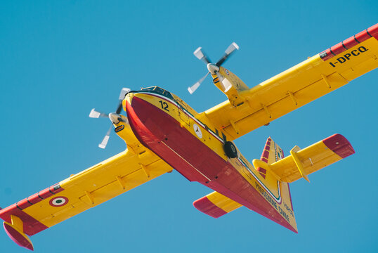 Viareggio, ITALY-JULY 07: Italian Canadair CL-415 known also as Super Scooper is  in flight over tuscanian sky trying to extinguish fire on mountain apuan alps on 7 july 2008 in viareggio, Italy
