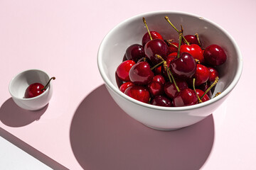 Fresh seasonal red cherries in strong sunlight