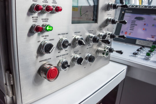 Oil rig computer controls & switches in operators room on rig floor.
