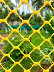 Abstract plastic net texture and green garden background