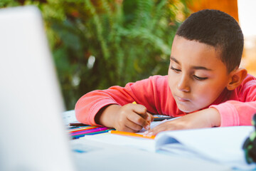 Boy doing homework outdoors