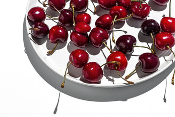Fresh seasonal red cherries in strong sunlight