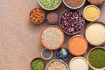 Collection different of legumes, beans, grains and seeds in bowls. Top view, flat lay, copy space.
