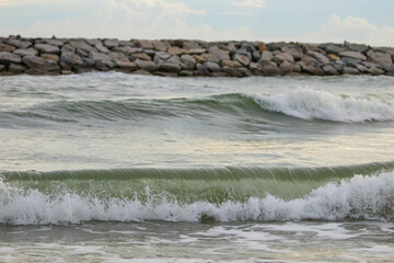 waves on the beach and background is blurred.