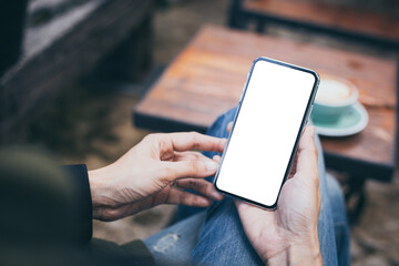 cell phone mockup image blank white screen.woman hand holding texting using mobile on desk at coffee shop.background empty space for advertise.work people contact marketing business,technology