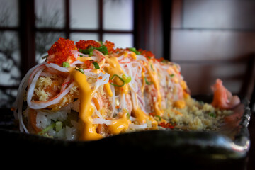 A selective focus plate of colourful and vibrant sushi against dull background. food showing contrast against background