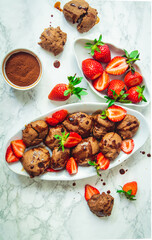 chocolate souffle biscuits, decorated by strawberry