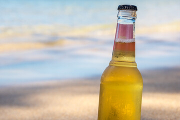 Cool refreshing alcoholic drink in the sand & shade at a tropical beach next to the ocean.  Concept for retirement, travel and stress free.