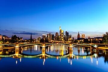 Fototapeta premium Beautiful view on Frankfurt am Main (european finance center city) downtown skyline cityscape during twilight blue hour, sunset, evening, night. Travel in Hessen. Hesse, Germany