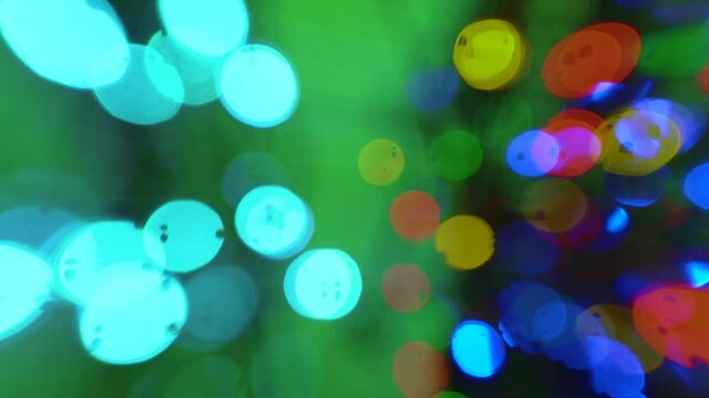 Disco lights blurred bokeh abstract backgrounds. Flashing colored lights in a blur. The bokeh effect. Dj matrix beam dmx fashion. Electric Christmas tree lights on green background