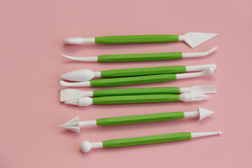 Naklejka premium set for pastry chef when preparing a cake, plastic set for mastic on a pink background