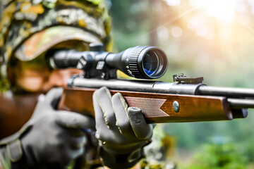 Shooter is on the hunting. Hunt prey rifle. Hunter man aiming on animals with gun