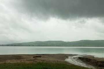 The lake in a cloudy day rain and reflections