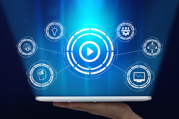 Easy to manage technology. Luminous hologram button play in tablet on hand