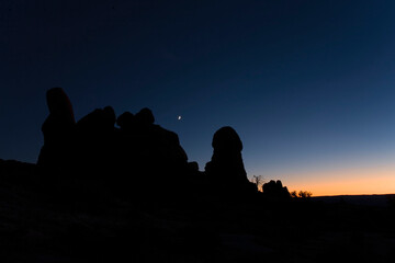 View of Turret Arch and moon in Arches National Park