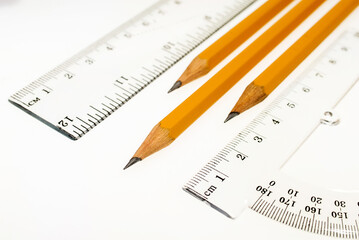 Ruler, protractor and pencils on a white background, drawing, stationery.