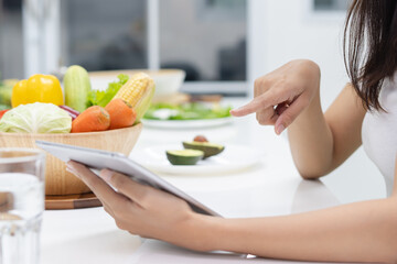 Obraz na płótnie Canvas vegan girl pointing touchpad choose dinner menu homemade cooked diet