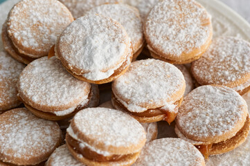 Fototapeta na wymiar Alfajores: Traditional Peruvian cookies filled with caramel and white sugar dust on top.