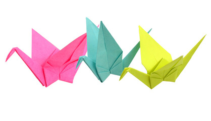 Origami birds flying over white