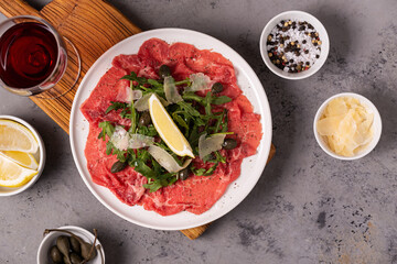 Marbled beef carpaccio with arugula, capers, lemon and parmesan cheese