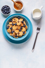 Trendy breakfast with mini pancakes, blueberries and chocolate chips.