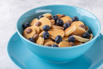 Trendy breakfast with mini pancakes, blueberries and chocolate chips.