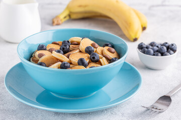 Trendy breakfast with mini pancakes, blueberries and chocolate chips.