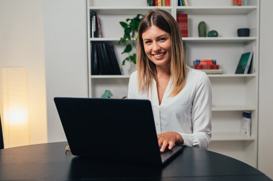 Cheerful beautiful caucasian girl student professional standing at home in office looking at camera, happy confident entrepreneur  laughing face posing alone, head shot close up view portrait. Webcam
