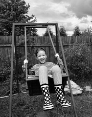 happy child swings on the swing