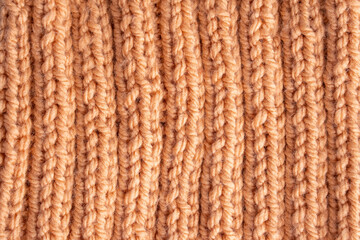 Wool hand knit pattern. Orange wool knitting texture background